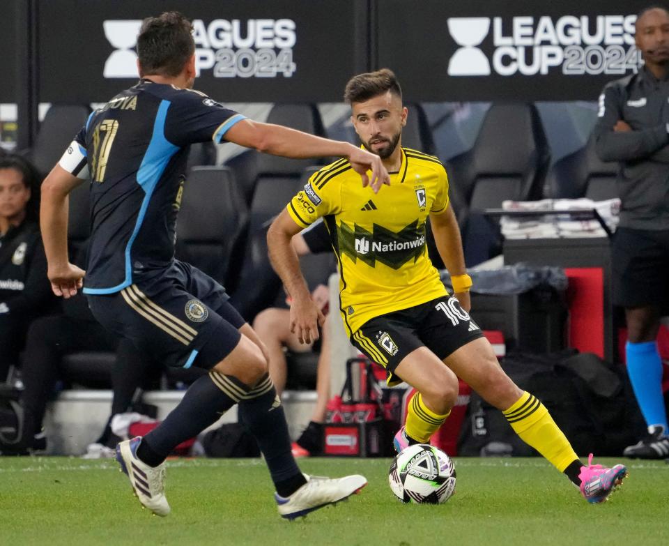 August 21, 2024; Columbus, Ohio, USA; 
Columbus Crew forward Diego Rossi (10) is defended by Philadelphia Union midfielder Alejandro Bedoya (11) during the first half of a semifinal Leagues Cup match at Lower.com Field.