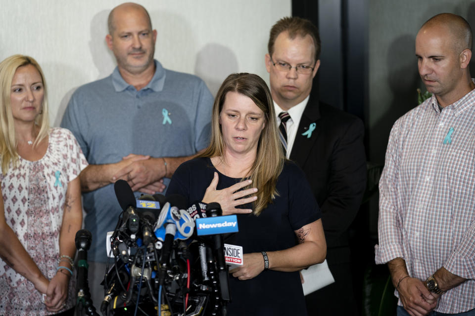 Nichole Schmidt, mother of Gabby Petito, whose death on a cross-country trip has sparked a manhunt for her boyfriend Brian Laundrie, speaks alongside, from left, Tara Petito, stepmother, Joseph Petito, father, Richard Stafford, family attorney, and Jim Schmidt, stepfather, during a news conference, Tuesday, Sept. 28, 2021, in Bohemia, N.Y. (AP Photo/John Minchillo)