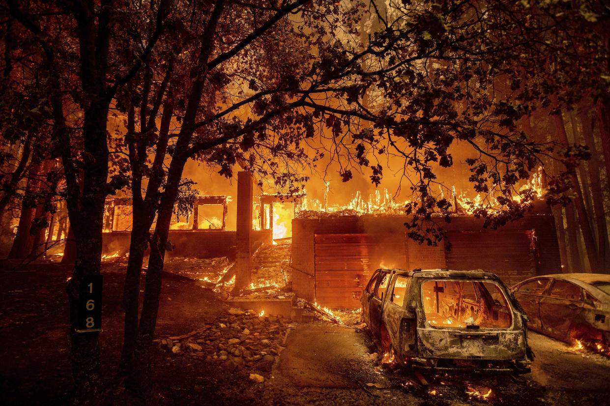 Flames consume a home as the Dixie Fire tears through the Indian Falls community in Plumas County, Calif. on Saturday, July 24, 2021.