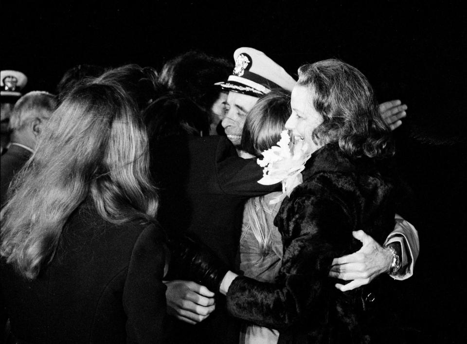 Capt. Jeremiah Denton Jr., USN, is hugged by his wife Jane and children after he arrived at the Norfolk Naval Air Station, Va., Feb. 15, 1973. Capt. Denton was shot down the night of July 18, 1965, during Operation Rolling Thunder, the first phase of the bombing of North Vietnam.