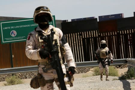 FILE PHOTO: Members of the Mexican National Guard are seen at the U.S. and Mexico border to stop migrants from crossing into the United States, as seen from Anapra, in Ciudad Juarez