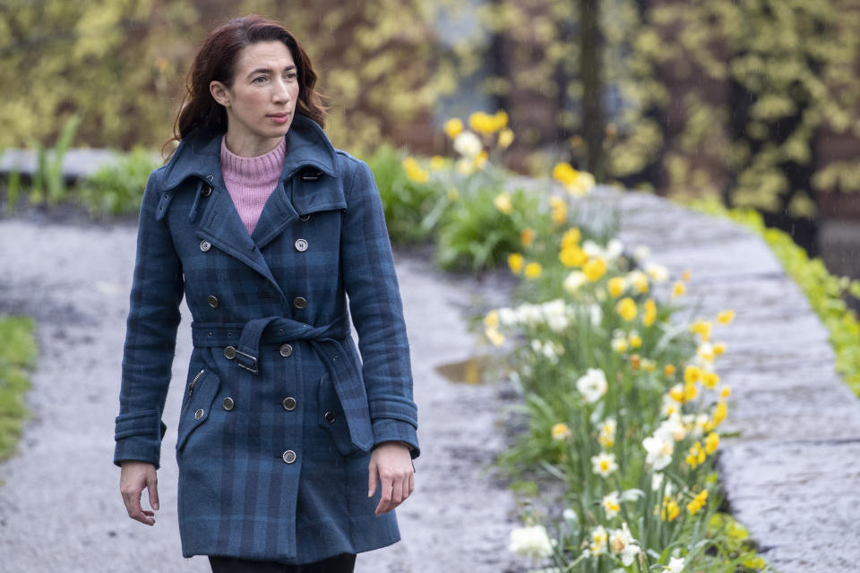 In this Friday, April 24, 2020, actress and part-time tour guide Megan Marod walks through the Hamilton Grange Historic site in the Hamilton Heights neighborhood of New York. Since those early days of the city’s coronavirus outbreak, out-of-towners have become scarce. In just one late February day, Marod lost income from cancellations by student groups that typically flood the city in the early spring — her most lucrative months. (AP Photo/Mary Altaffer)