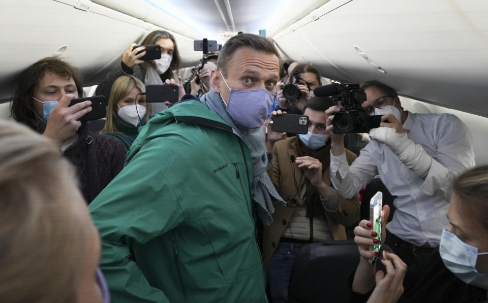 FILE - Alexei Navalny is surrounded by journalists inside a plane carrying him back to Russia from the airport near Berlin, Germany, on Sunday, Jan. 17, 2021. Navalny, who was President Vladimir Putin’s fiercest political foe, died in a Russian prison on Feb. 16, 2024. Over the last decade, Putin's Russia evolved from a country that tolerates at least some dissent to one that ruthlessly suppresses it. Arrests, trials and long prison terms — once rare — are commonplace. (AP Photo/Mstyslav Chernov, File)