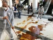 Protestors from climate change awareness collective Extinction Rebellion chant slogans and smear oil across the floor at the lobby of the Africa Oil Week conference in Cape Town