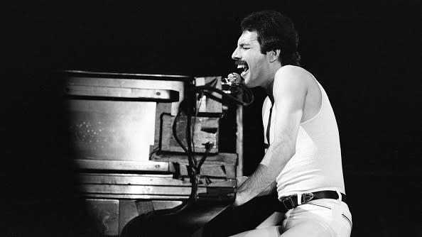 Black and white image of Freddie Mercury at the piano