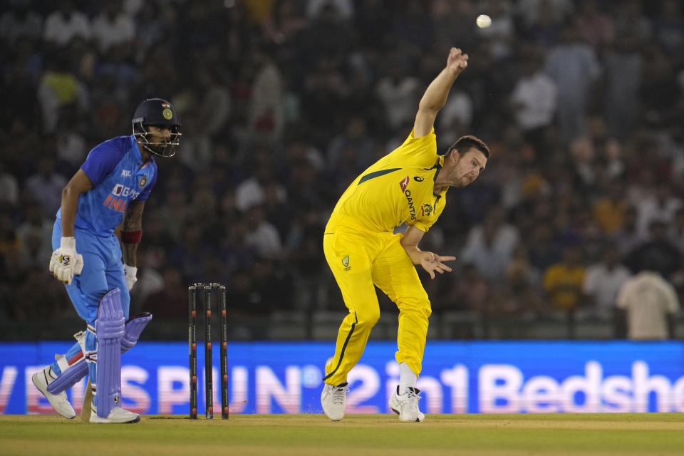 Australia's Josh Hazlewood, right, bowls a delivery during the first T20 cricket match between India and Australia, in Mohali, India, Tuesday, Sept. 20, 2022. (AP Photo/Manish Swarup)