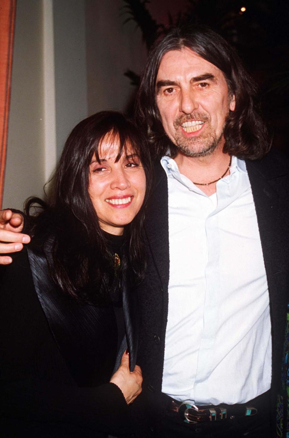 George Harrison with Olivia at his 50th birthday party, 1993. (Photo: Dave Benett/Getty Images)