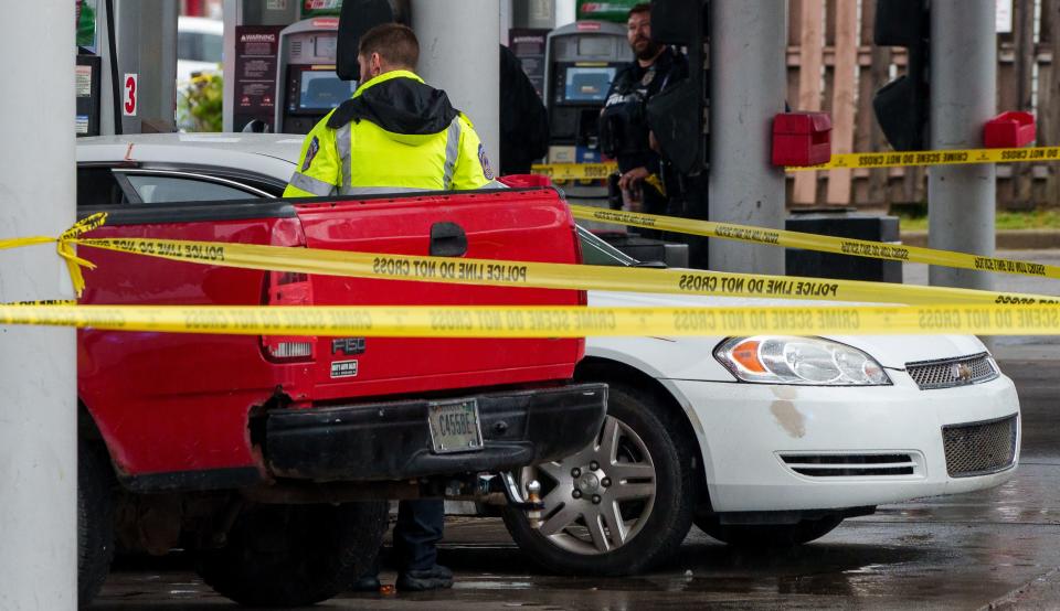 Law enforcement investigate Thursday, Oct. 19, 2023, after a man in a vehicle was shot at least once by Indianapolis Metropolitan Police Department officers near the intersection of Shelby and Raymond streets on the city's south side.