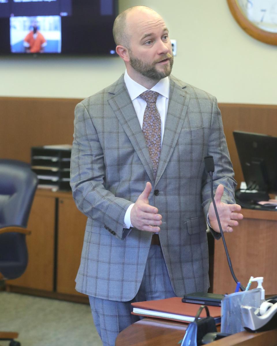 Defense attorney Noah Munyer speaks Tuesday in Summit County Common Pleas Court as Ahmere Williams, his client, attends via video from the Summit County Jail.