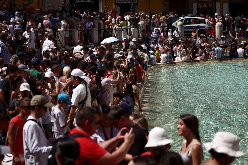 FILE PHOTO: Crowds of tourists visit the Trevi Fountain in Rome