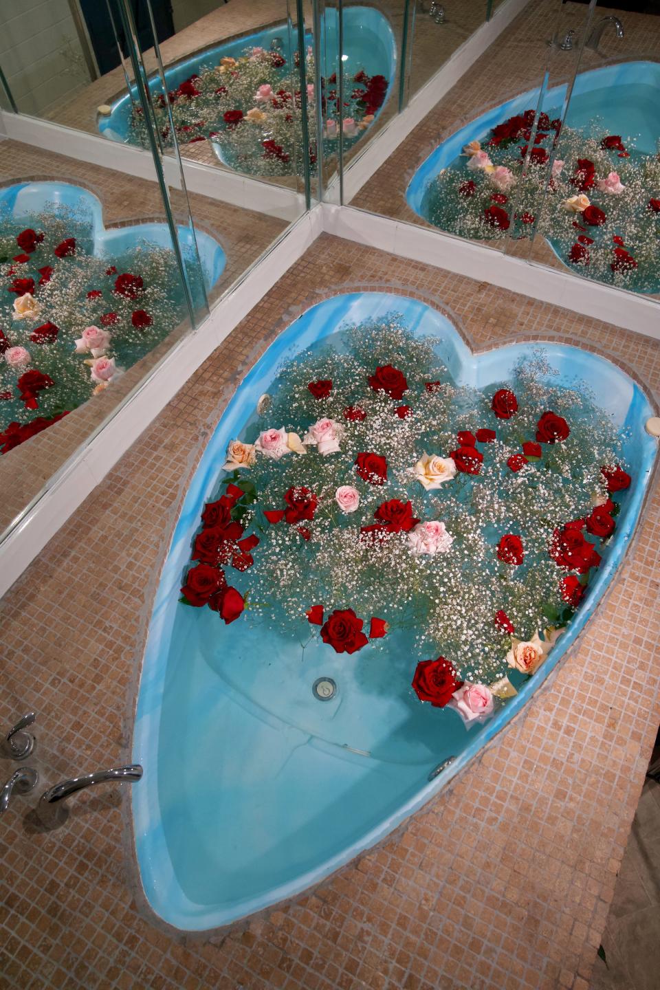 Margaret and Corey Bienert of A Pretty Cool Hotel Tour prepped this heart-shaped tub with roses and baby's breath before a shoot at the Flamingo Inn, Rosemead, California.