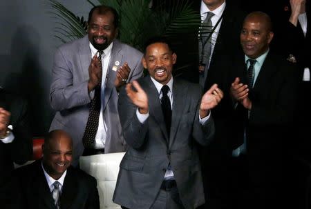 Actor Will Smith (C) applauds during a public memorial service for the late boxer Muhammad Ali in Louisville, Kentucky, U.S. June 10, 2016. REUTERS/Lucas Jackson