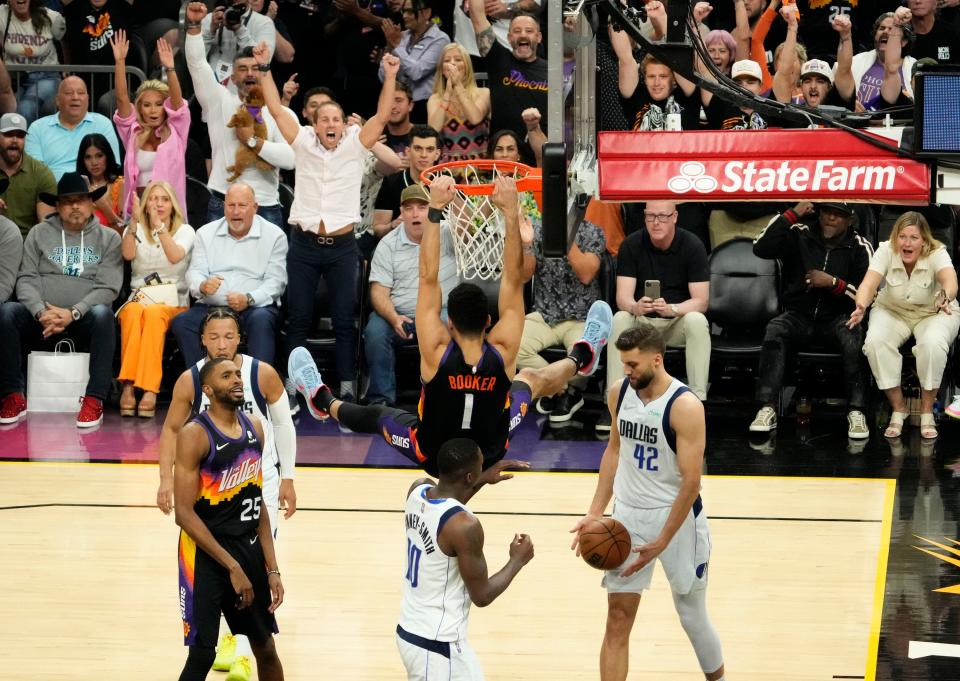 May 10, 2022; Phoenix, Arizona, USA; Phoenix Suns guard Devin Booker (1) slam-dunks the ball over Dallas Mavericks forward Dorian Finney-Smith (10) during game five of the second round for the 2022 NBA playoffs at Footprint Center.