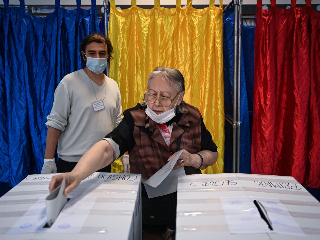 A voter casts a ballot at a polling station in Bucharest on Sunday (AFP via Getty Images)