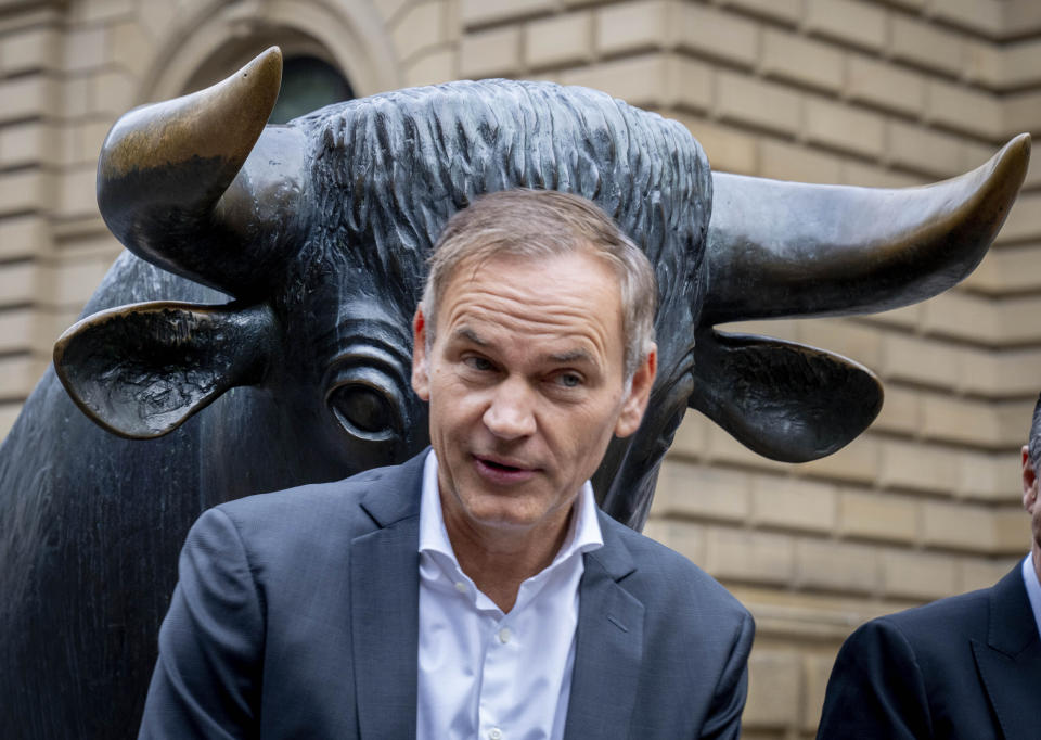 CEO of Porsche car maker Oliver Blume stands in front of the bull statue at the start of Porsche's market listing at the stock market in Frankfurt, Germany, Thursday, Sept. 29, 2022. (AP Photo/Michael Probst)