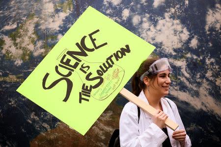 A protestor holds a sign in support of science during the March For Science in Seattle, Washington, U.S. April 22, 2017. REUTERS/David Ryder