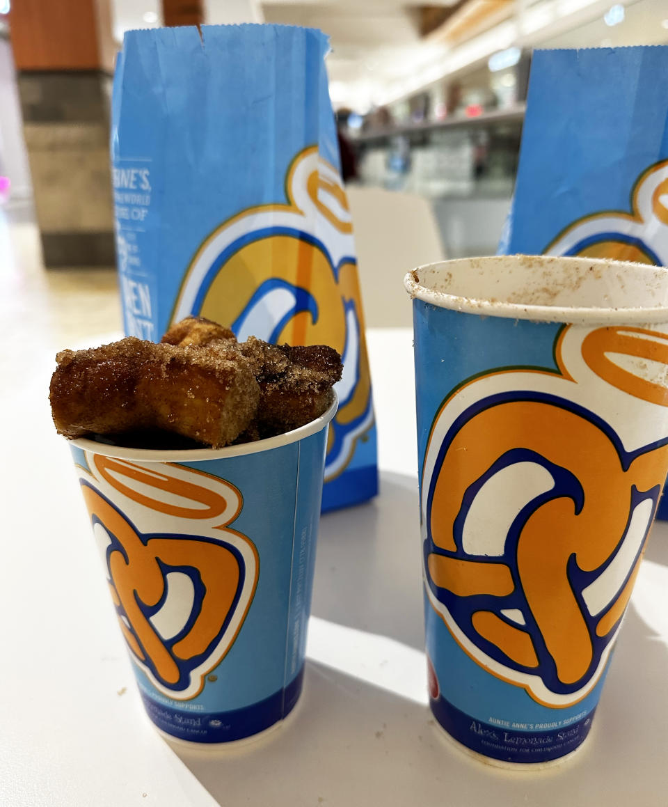 Auntie Anne's Cinnamon Sugar Pretzel Nuggets overflowing out of the cup. There are still some in the large cup that wouldn't fit. (Courtesy Joseph Lamour)