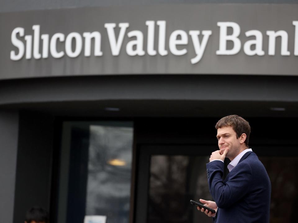 A man stands outside Silicon Valley Bank