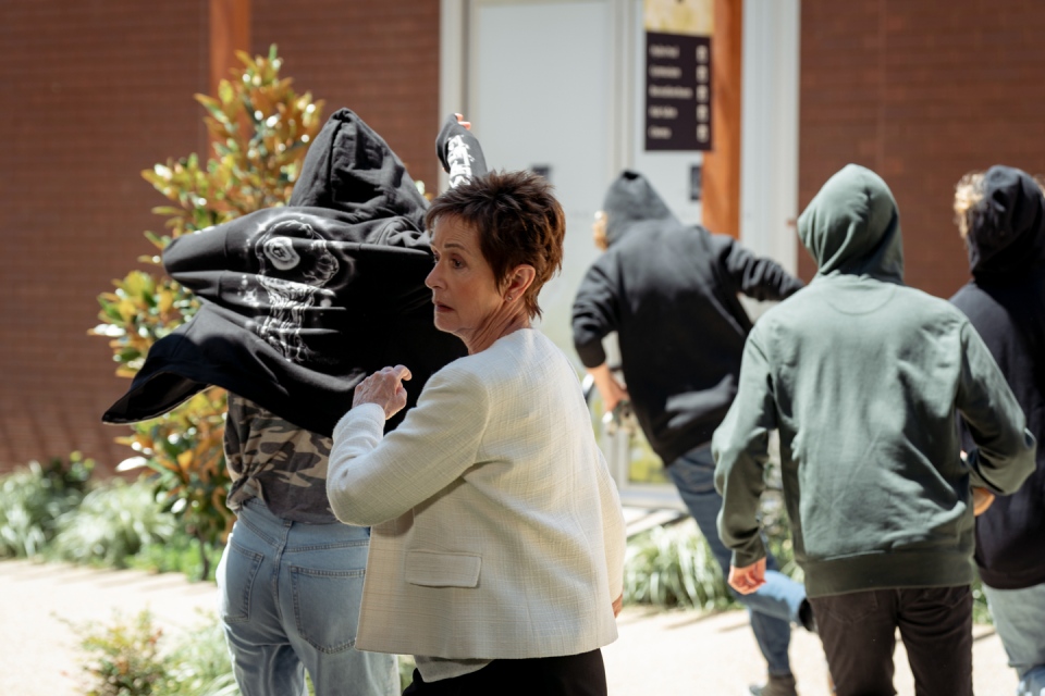 susan kennedy with hooded figures in neighbours