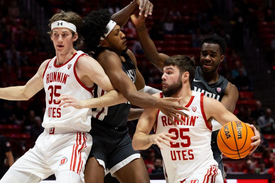 Utah Utes guard Rollie Worster (25) drives the ball with Washington State Cougars forward AJ Rohosy (15), left, and Washington State Cougars guard Kymany Houinsou (31), right, on defense during a men’s college basketball game between the University of Utah and Washington State University at the Jon M. Huntsman Center in Salt Lake City on Friday, Dec. 29, 2023.