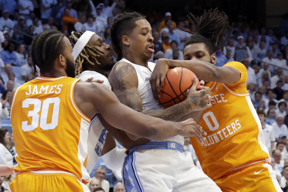 North Carolina forwards Armando Bacot, second from right, and Jae'Lyn Withers, second from left, battle Tennessee guard Josiah-Jordan James (30) and forward Jonas Aidoo (0) for a rebound during the first half of an NCAA college basketball game Wednesday, Nov. 29, 2023, in Chapel Hill, N.C. (AP Photo/Chris Seward)