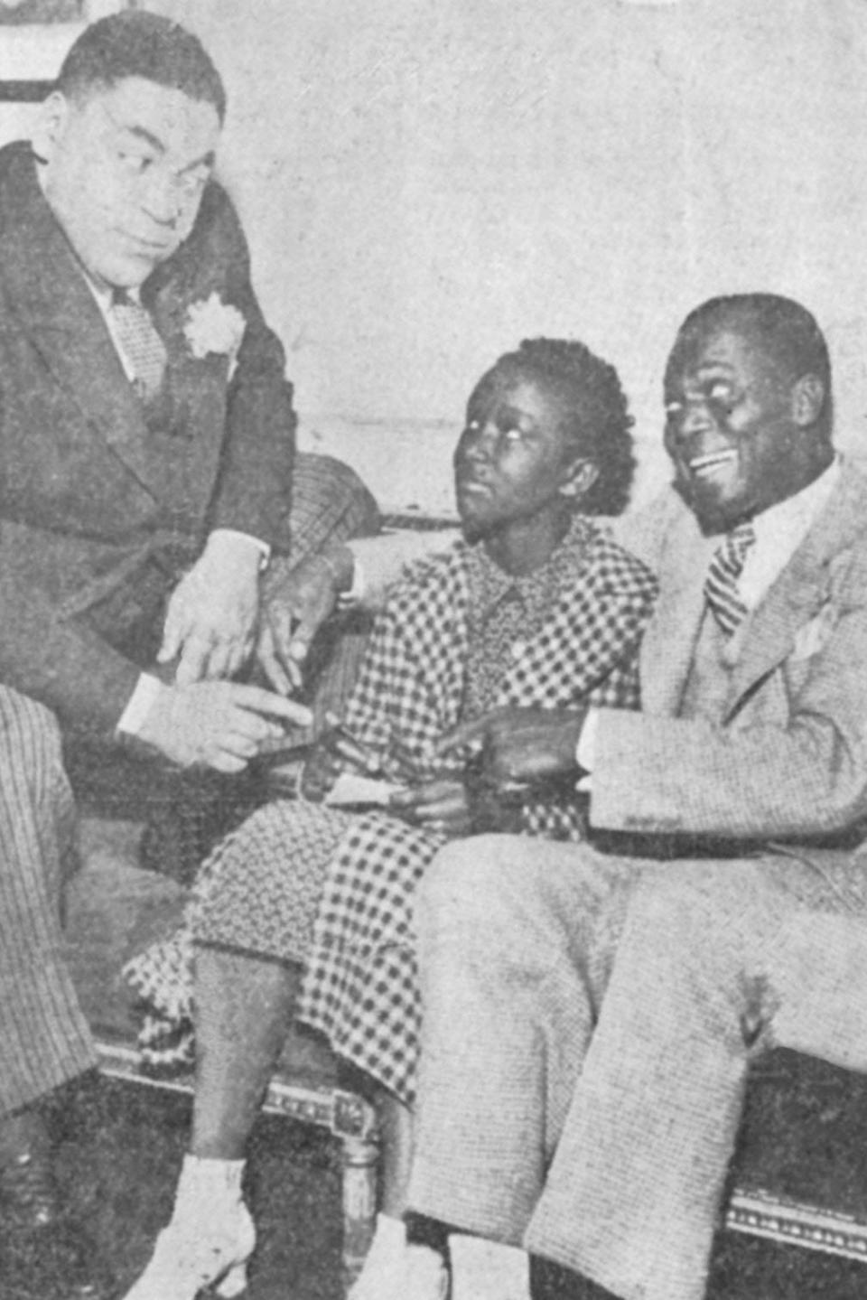 Akron spelling champ MacNolia Cox, 13, meets composer Fats Waller, left, and dancer Bill "Bojangles'' Robinson on May 4, 1936, at the RKO Palace Theatre in Cleveland.