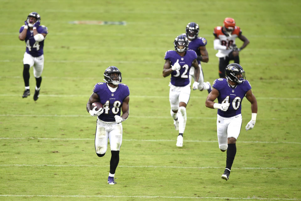 Baltimore Ravens inside linebacker Patrick Queen (48) returns a fumble recovery 53 yards for a touchdown on a ball dropped by Cincinnati Bengals wide receiver Mike Thomas, top right, during the second half of an NFL football game, Sunday, Oct. 11, 2020, in Baltimore. The Ravens won 27-3. (AP Photo/Gail Burton)