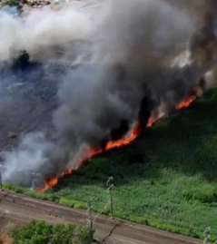 A brush fire burns in the Meadowlands near the NJ Turnpike in Secaucus Thursday.