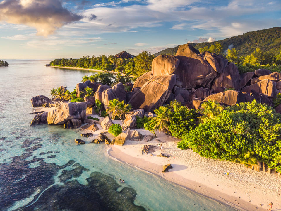 A beautiful beach with rock formations and jungle.