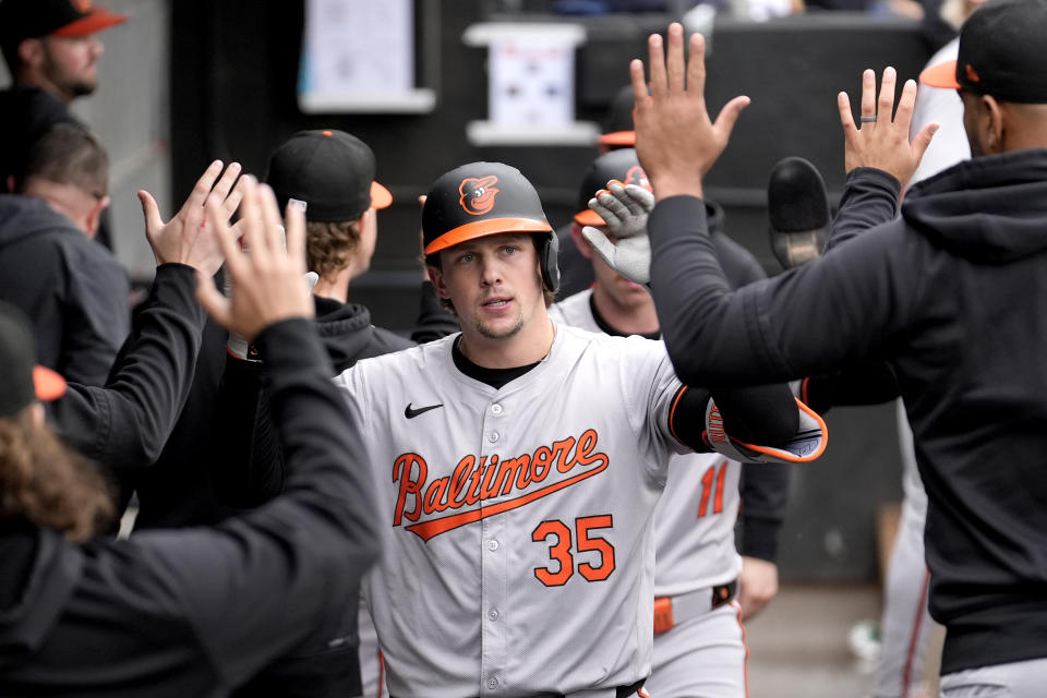 Baltimore Orioles' Adley Rutschman celebrates in the dugout after his two-run home run off Chicago White Sox starting pitcher Garrett Crochet during the six inning of a baseball game, Sunday, May 26, 2024, in Chicago. (AP Photo/Charles Rex Arbogast)