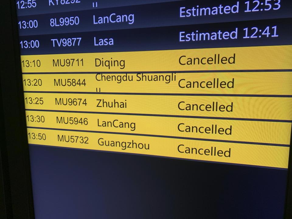 A screen displays cancelled China Eastern Airline flights at Kunming Changshui International Airport, Tuesday, March 22, 2022, in Kunming in southwest China’s Yunnan province. No survivors have been found among the 132 people onboard a China Eastern Boeing 737-800 that departed from Kunming and crashed Monday in the southern province of Guangxi. As family members gathered at the destination and departure airports, what caused the crash remains a mystery. (AP Photo/Dake Kang)