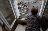 Cycling - Tour de France cycling race - The 237.5 km (147.5 miles) Stage 4 from Saumur to Limoges, France - 05/07/2016 - A fan watches cyclists from a window. REUTERS/Juan Medina