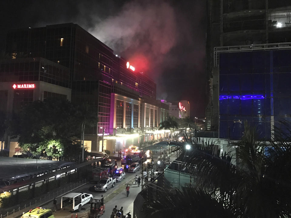 <p>Smoke rises from the Resorts World Manila complex, June 2, 2017 in Manila, Philippines. Gunshots and explosions rang out early Friday at a mall, casino and hotel complex near Manila's international airport in the Philippine capital, sparking a security alarm amid an ongoing Muslim militant siege in the country's south. (Photo: Bullit Marquez/AP) </p>