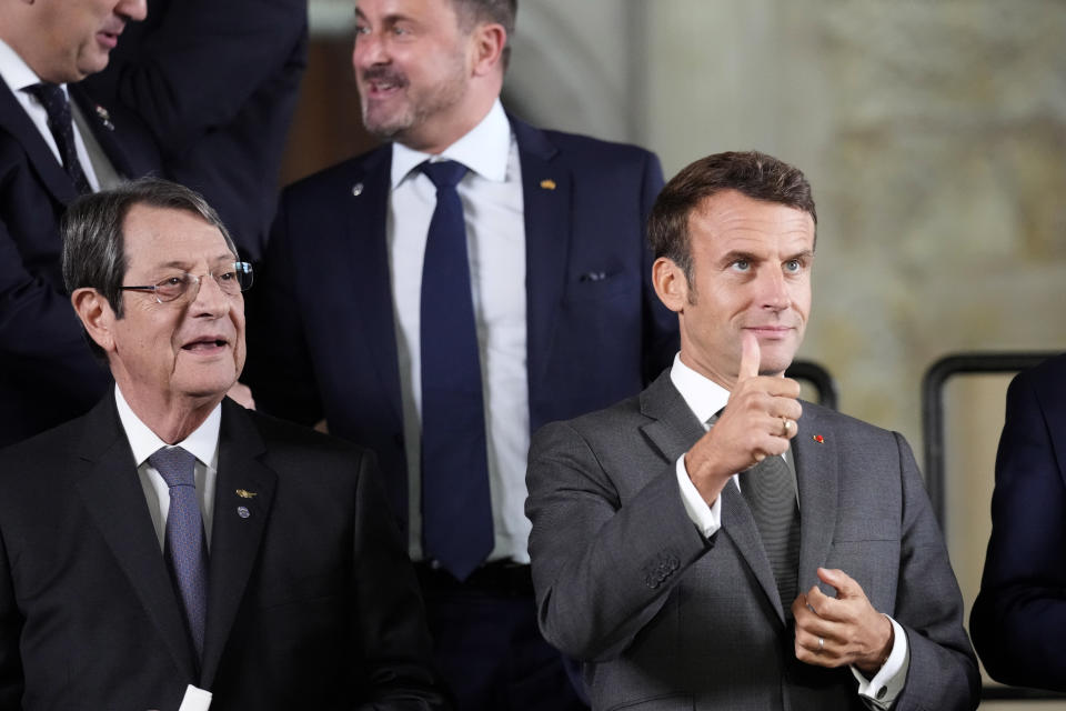 France's President Emmanuel Macron gestures while posing for a group photo during a meeting of the European Political Community at Prague Castle in Prague, Czech Republic, Thursday, Oct 6, 2022. Leaders from around 44 countries are gathering Thursday to launch a "European Political Community" aimed at boosting security and economic prosperity across the continent, with Russia the one major European power not invited. (AP Photo/Darko Bandic)