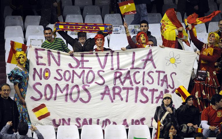 Spanish supporters hold a banner reading "In Sevilla we are not racist, we are artists" before the friendly football match Spain vs England at the Ramon Sanchez Pizjuan in Sevilla on February, 11 2009