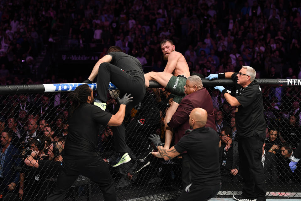 Conor McGregor attempts to leave the Octagon in chase of Khabib Nurmagomedov after their UFC lightweight championship bout at UFC 229 inside T-Mobile Arena on Saturday in Las Vegas. (Josh Hedges/Zuffa LLC)