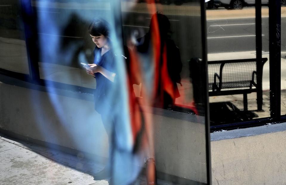 Tamara Cedillo waits for a bus after her first job in Torrance. I