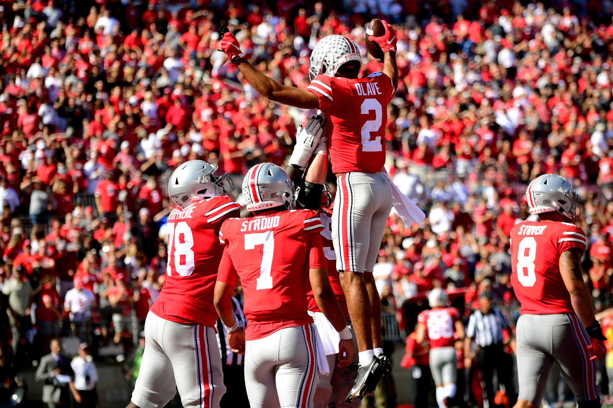 COLUMBUS, OHIO - OCTOBER 09: Teammates lift Chris Olave #2 of the Ohio State Buckeyes after his touchdown in the third quarter during a game against the Maryland Terrapins at Ohio Stadium on October 09, 2021 in Columbus, Ohio. (Photo by Emilee Chinn/Getty Images)