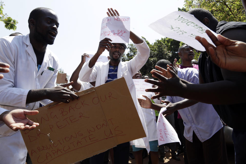 A group of Zimbabwean doctors sing as they protest at Parirenyatwa hospital in Harare, Zimbabwe, Sunday, Sept. 15, 2019. The Zimbabwe Hospital Doctors Association, which represents hundreds of junior doctors countrywide, said the association's president Peter Magombeyi was abducted on Saturday, days after receiving threats on his phone. (AP Photo/Themba Hadebe)