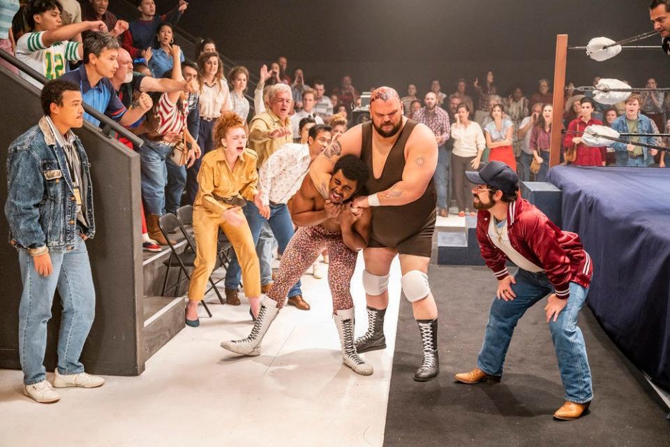 Patrick Cox as Crusher Yurkov has Joseph Lee Anderson as Rocky Johnson in a headlock during a Memphis-set episode of NBC's "Young Rock." Looking on are Bradley Constant as Dwayne, left, and Ryan Pinkston as Downtown Bruno, right.