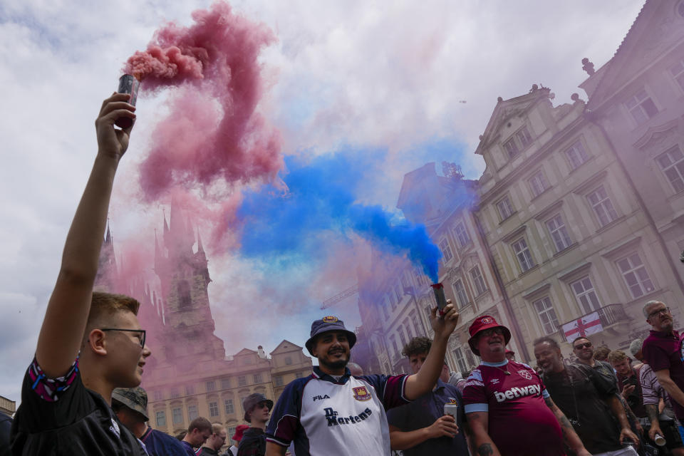 Fans of West Ham United cheer ahead of the Conference League final soccer match between West Ham United and Fiorentina at the Old Town Square in Prague, Czech Republic, Wednesday, June 7, 2023. (AP Photo/Darko Vojinovic)