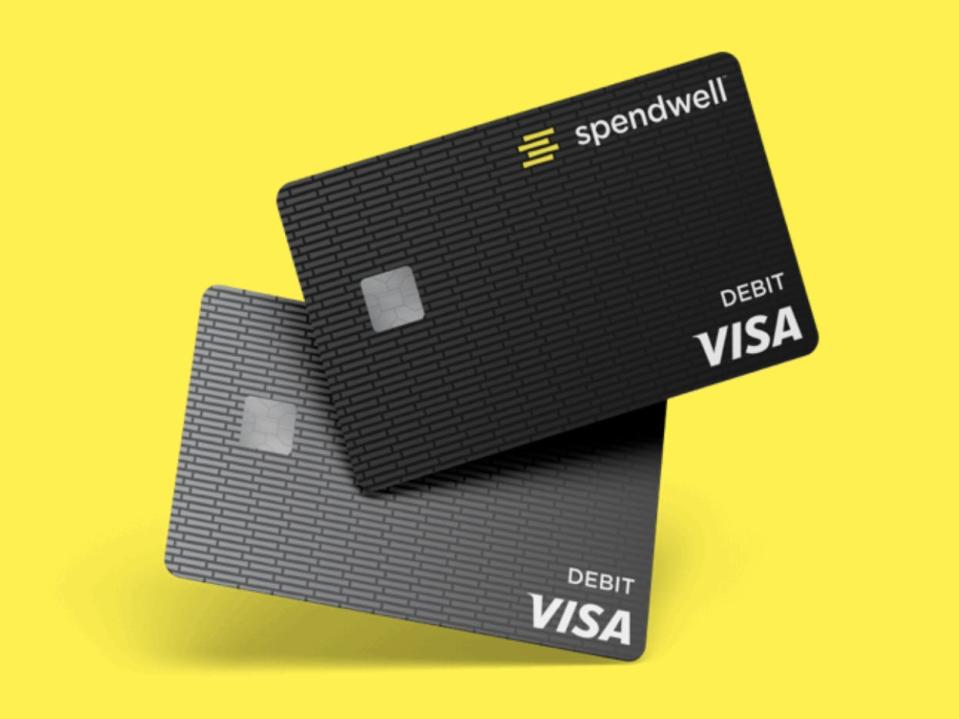 Two Spendwell Visa debit cards, one black and one grey, appear against a yellow background