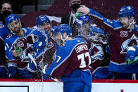 Colorado Avalanche left wing J.T. Compher (37) is congratulated by teammates after scoring a hat trick against Los Angeles Kings goaltender Calvin Petersen (40) during the second period of an NHL hockey game Wednesday, May, 12, 2021, in Denver. (AP Photo/Jack Dempsey)