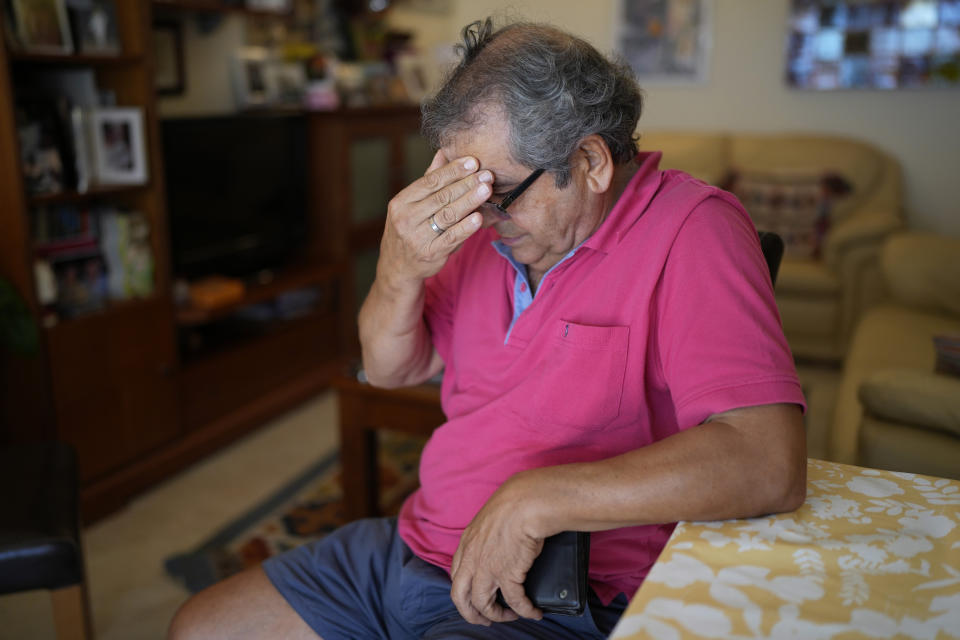 Antonio Grosso tears up after reading aloud the letter his daughter wrote him saluting his courage when he publicly recounted his story of sex abuse by members of the church in a 2002 Portuguese magazine interview, at his home in Oeiras, outside Lisbon, Wednesday, July 12, 2023. Grosso's personal journey has taken him from would-be priest studying as a child at a Portuguese seminary to co-founder of the first church sex abuse victim association in Portugal. (AP Photo/Armando Franca)