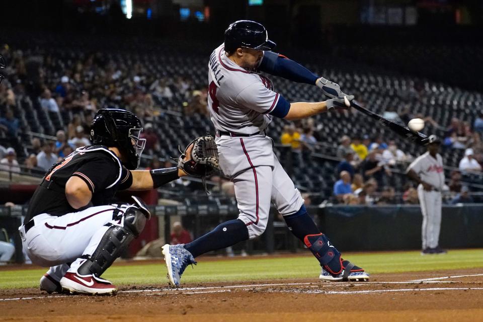 Atlanta Braves' Adam Duvall connects for a two run home run against the Arizona Diamondbacks during the first inning of a baseball game, Wednesday, Sept. 22, 2021, in Phoenix. (AP Photo/Matt York)