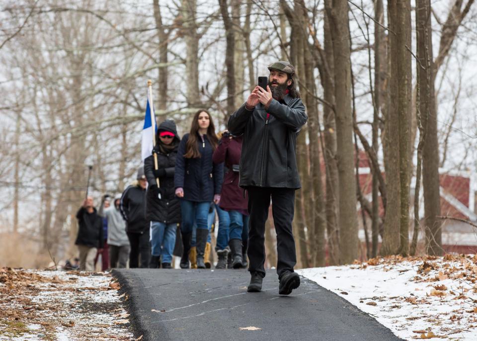 Frank Staples, a founder of Absolute Defiance, leads a group of protesters and records the events during a march to Gov. Chris Sununu's home Sunday, Jan. 3, 2021 in Newfields.