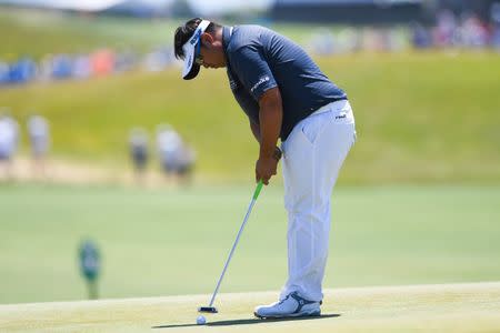 Jun 16, 2018; Southampton, NY, USA; Kiradech Aphibarnrat putts the seventeenth green during the third round of the U.S. Open golf tournament at Shinnecock Hills GC - Shinnecock Hills Golf C. Mandatory Credit: Dennis Schneidler-USA TODAY Sports