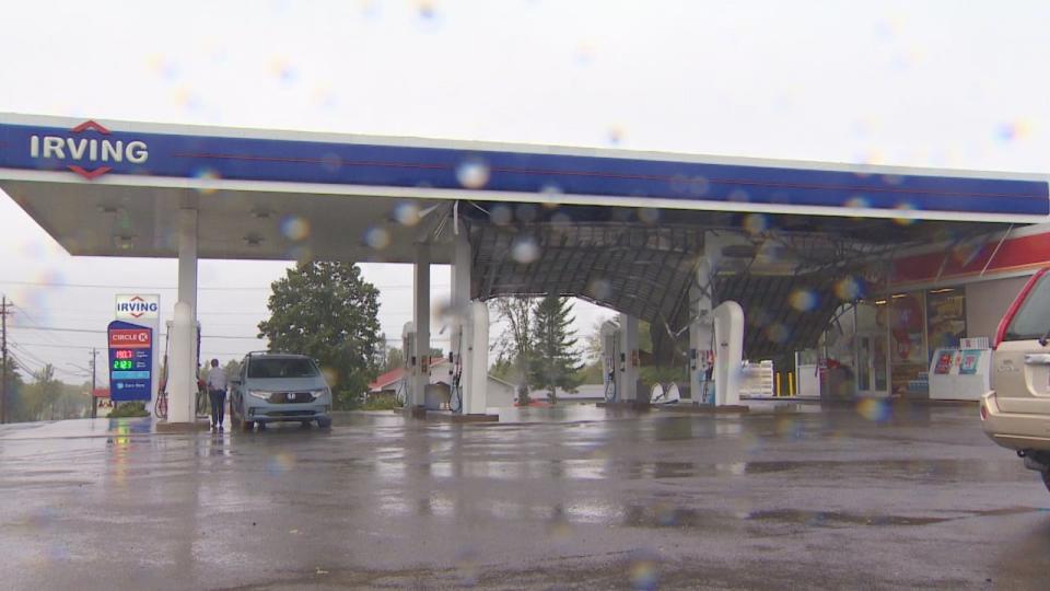 As the underside of the roof at a New Maryland gas station slowly fell inwards, one person continued to pump their gas only a few pumps over.