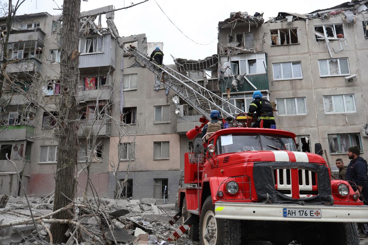 Firefighters work to extinguish a fire as they look for potential victims after today Russian rocket attack in Sloviansk, Donetsk region, Ukraine (AP)