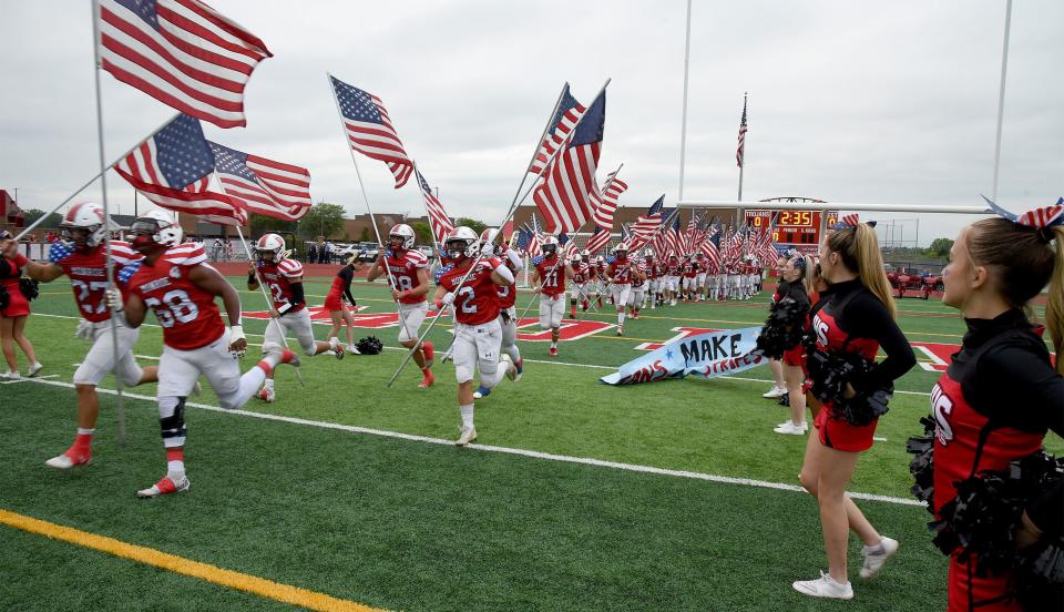 Monroe takes the field wearing their new red, white and blue jersey's to honor the military and first responders on Friday, September 8, 2023.